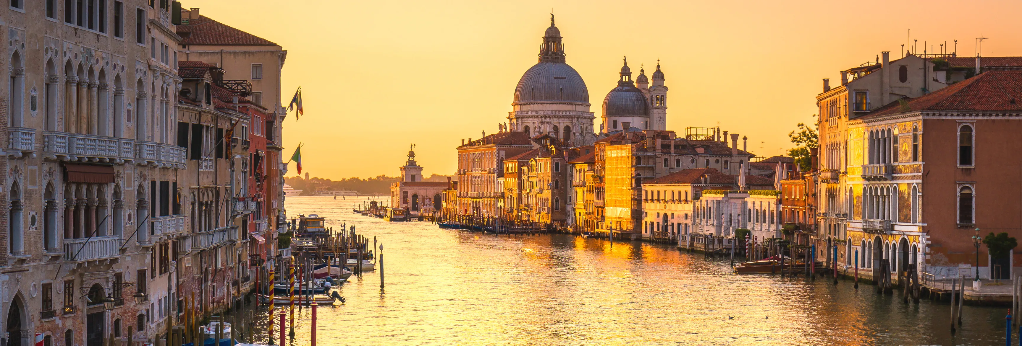 Venice canal and historic buildings at golden hour