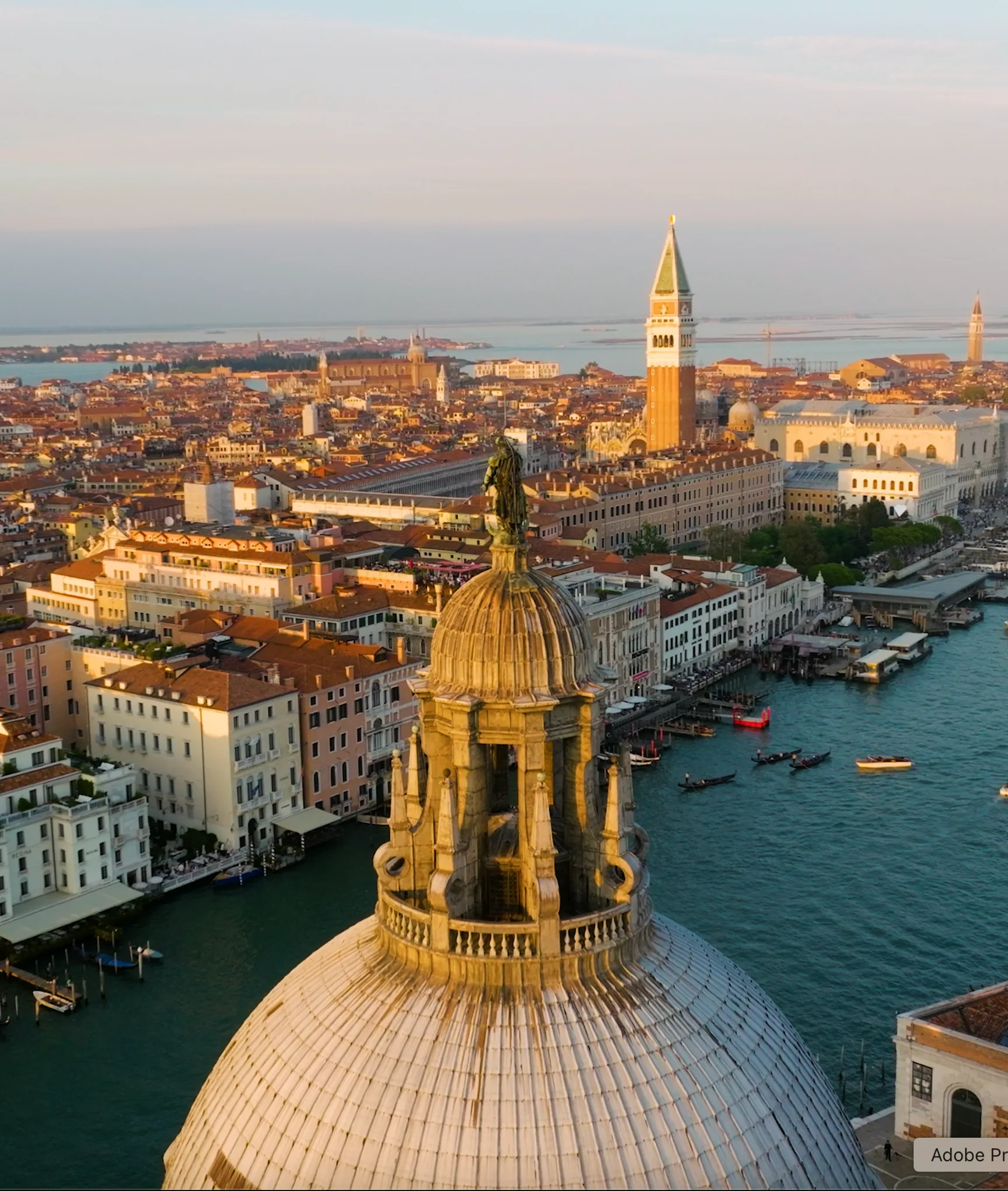Aerial view of Venice rooftops and church dome at sunset